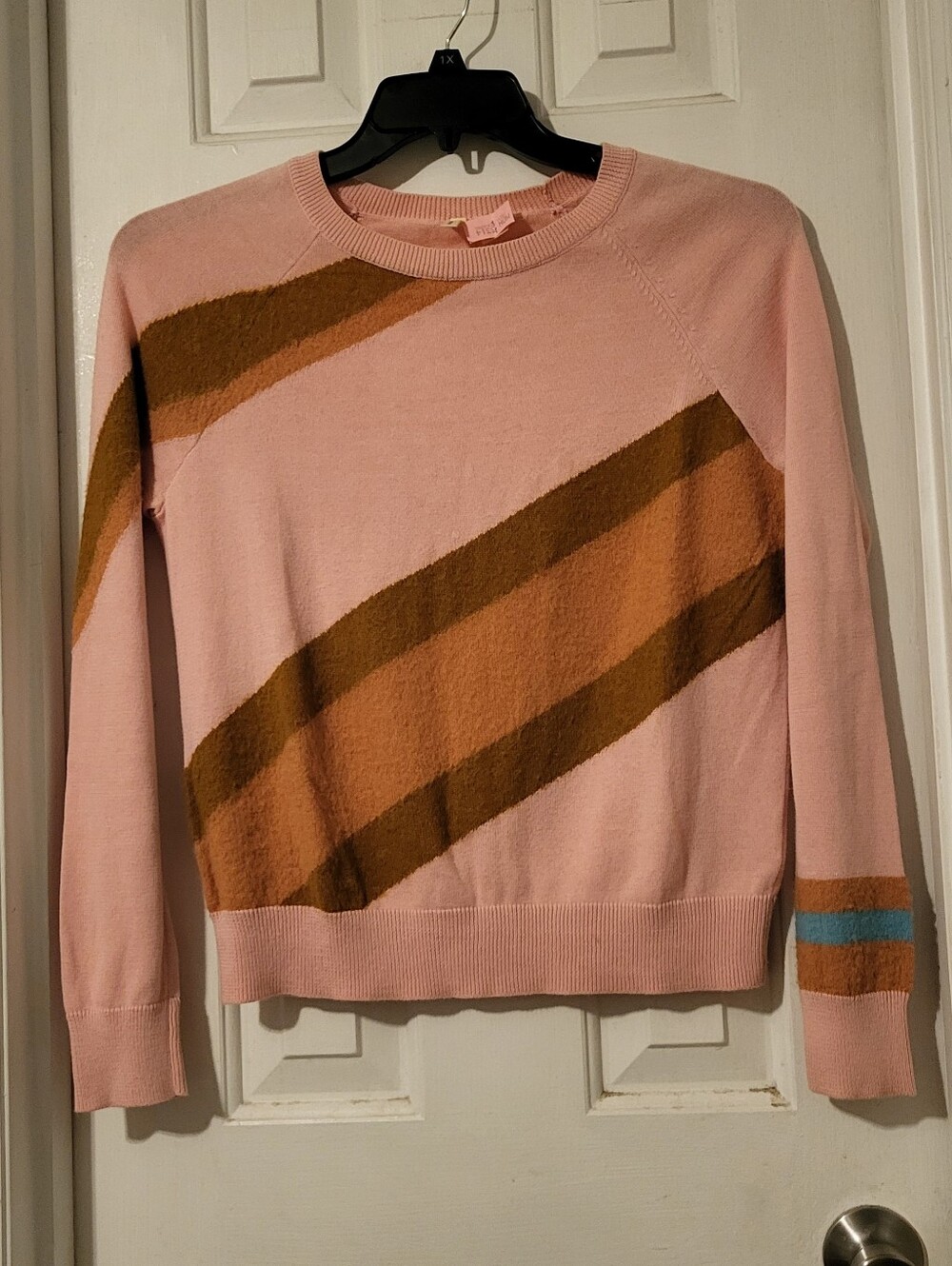 Moth Pink Sweater with Brown and Orange Diagonal Stripes and Blue Cuff Accent